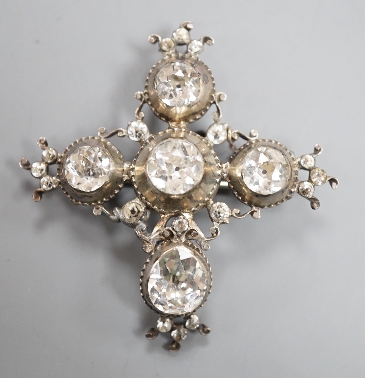 A 19th century white metal and paste cluster set quatrefoil shaped pendant brooch, 56mm, (a.f.).